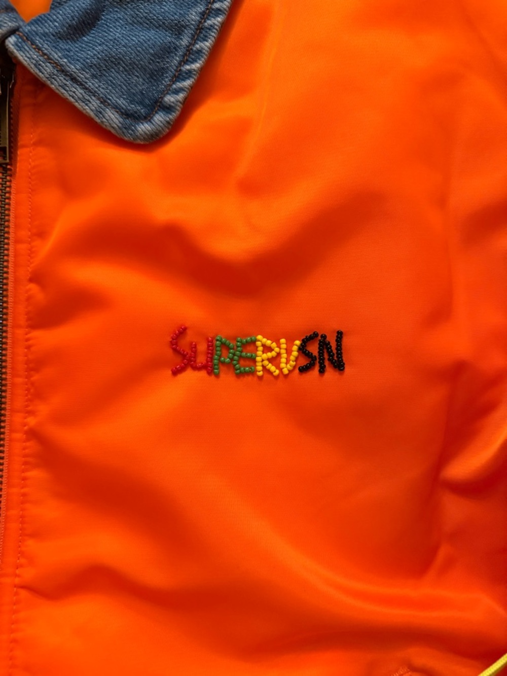 Orange Bomber Supervsn Studios Jacket with Denim Collar and beaded Logo